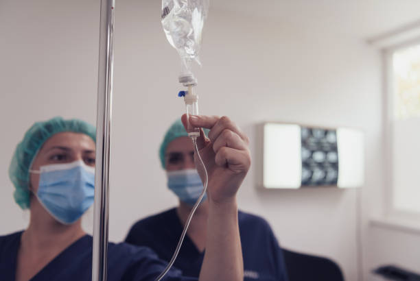 Clinician administering an intravenous drip