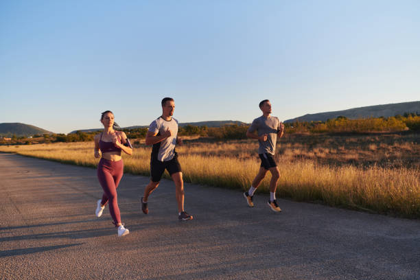 Athletes running together at sunrise