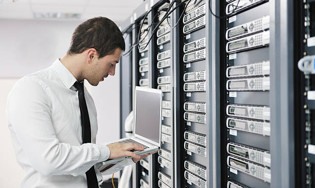 Engineer monitoring servers on a laptop